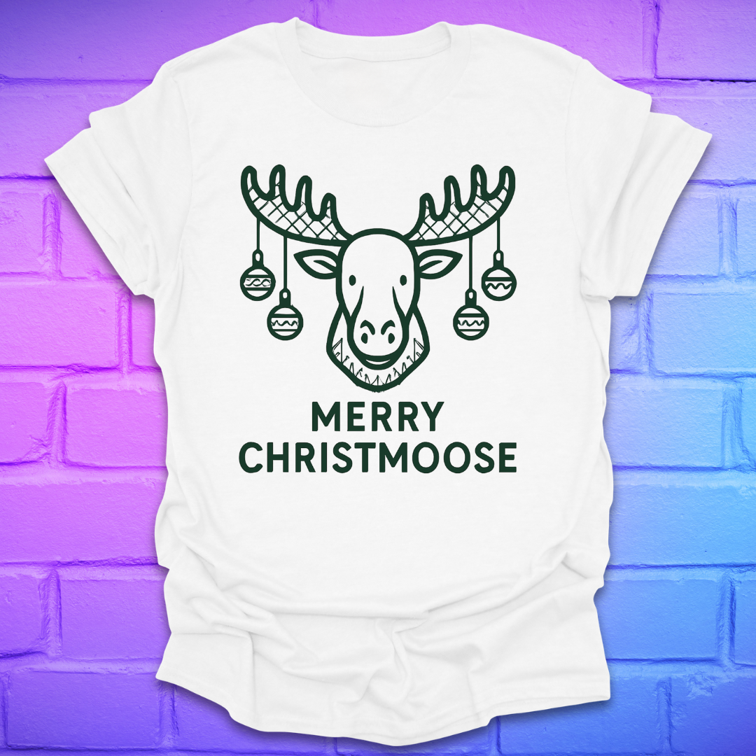 White t-shirt with a moose graphic and 'Merry Christmoose' text on a brick wall background