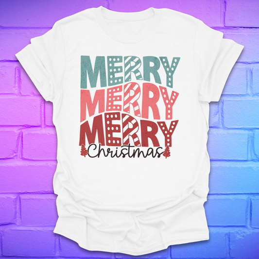 White t-shirt with 'Merry Christmas' text in colorful letters on a purple brick wall background