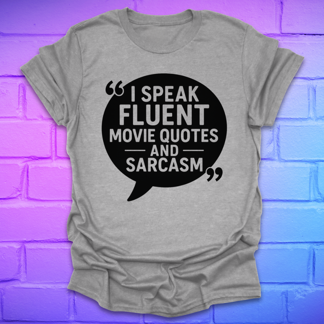 Gray t-shirt with black speech bubble graphic and text on a blue and purple brick wall background