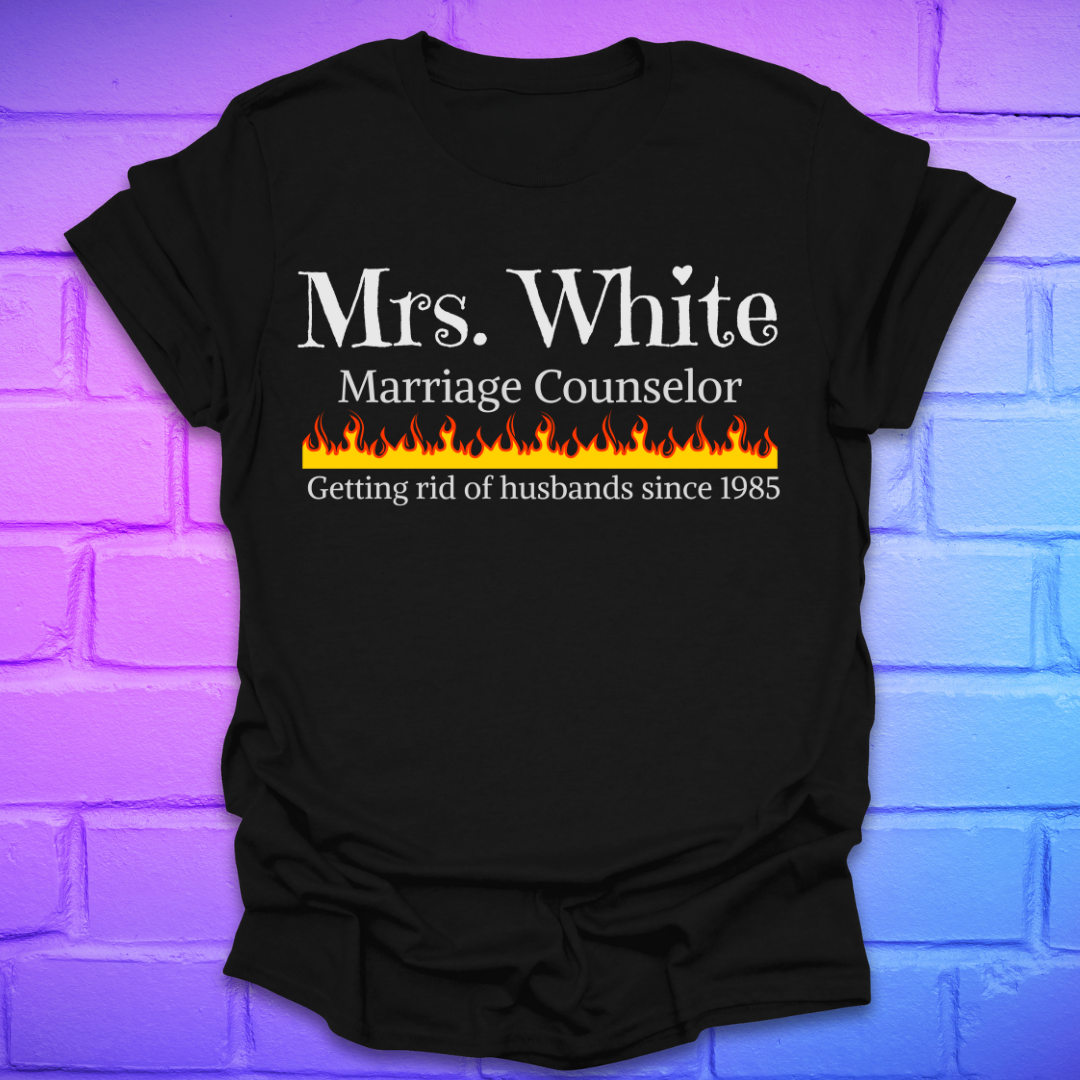 Black t-shirt with text 'Mrs. White Marriage Counselor Getting rid of husbands since 1985' on a brick wall background