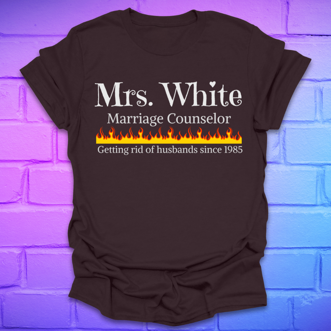 Brown t-shirt with text 'Mrs. White Marriage Counselor Getting rid of husbands since 1985' on a brick wall background