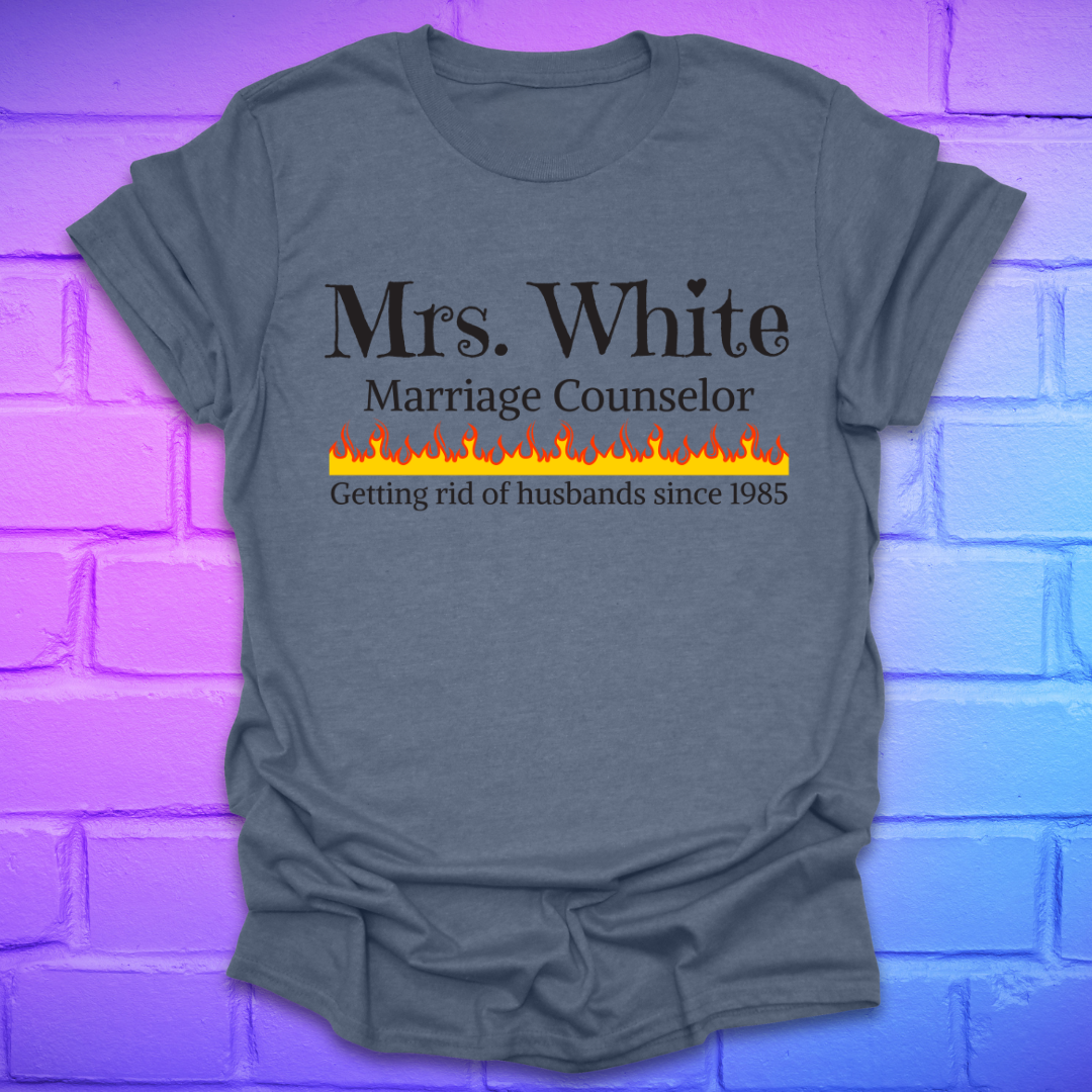 Indigo t-shirt with text 'Mrs. White Marriage Counselor Getting rid of husbands since 1985' on a brick wall background