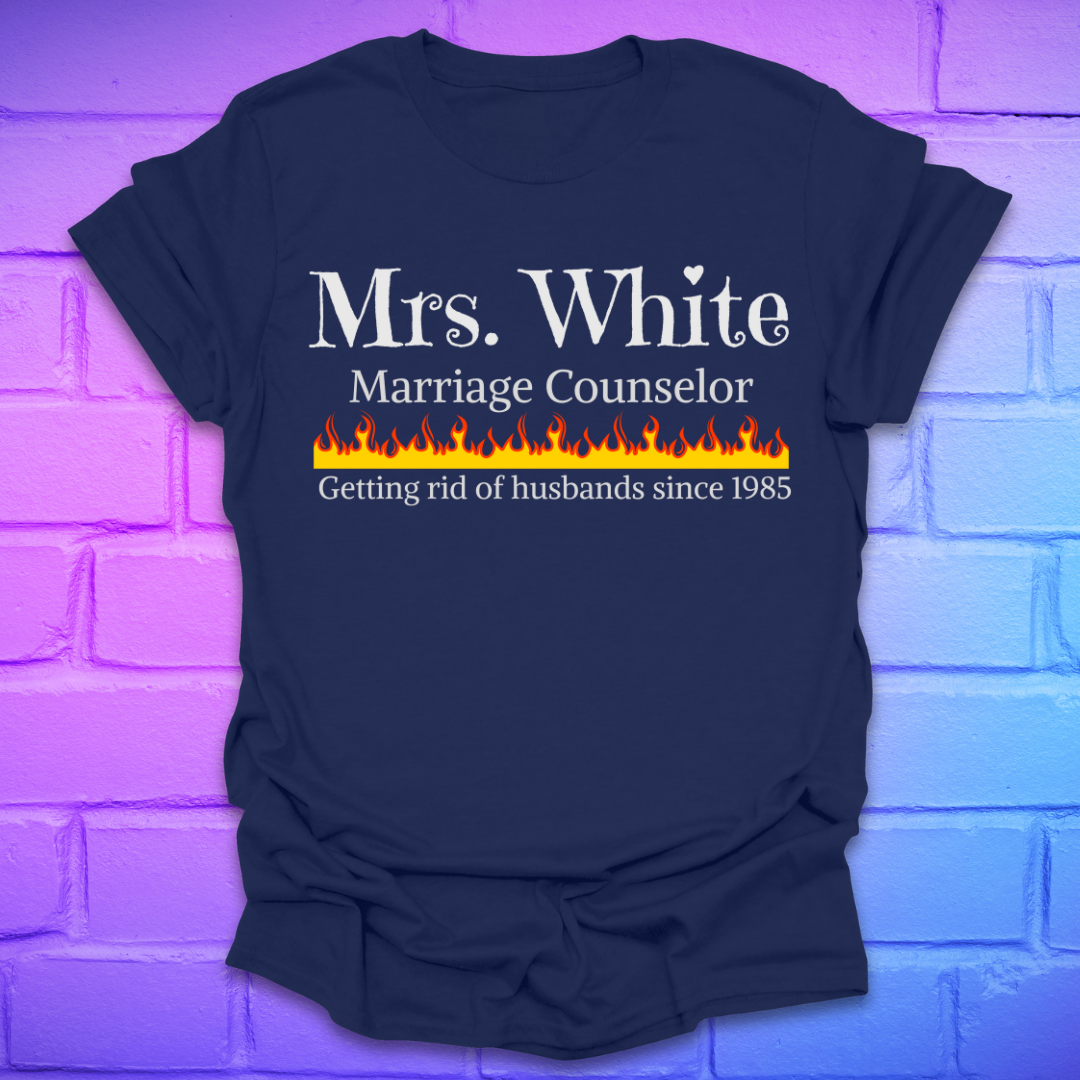Navy blue t-shirt with text 'Mrs. White Marriage Counselor Getting rid of husbands since 1985' on a brick wall background