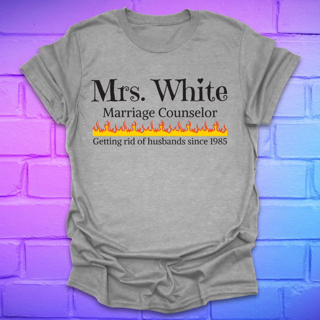 Grey t-shirt with text 'Mrs. White Marriage Counselor Getting rid of husbands since 1985' on a brick wall background