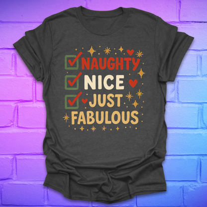 Dark grey t-shirt with colorful text design, 'naughty nice, just fabulous' on a brick wall background
