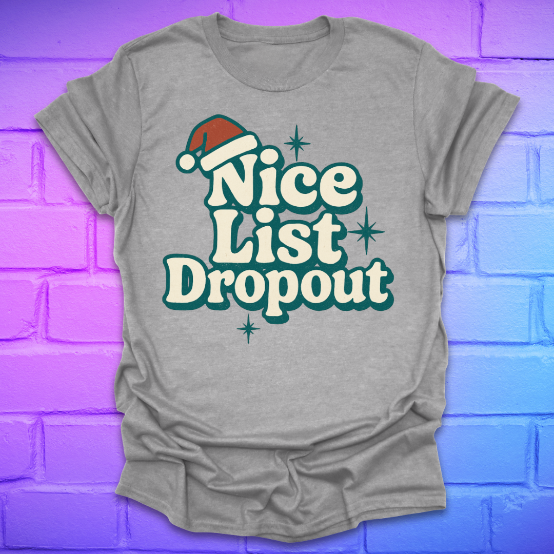 Gray t-shirt with 'Nice List Dropout' text and Santa hat graphic on a colorful brick wall background