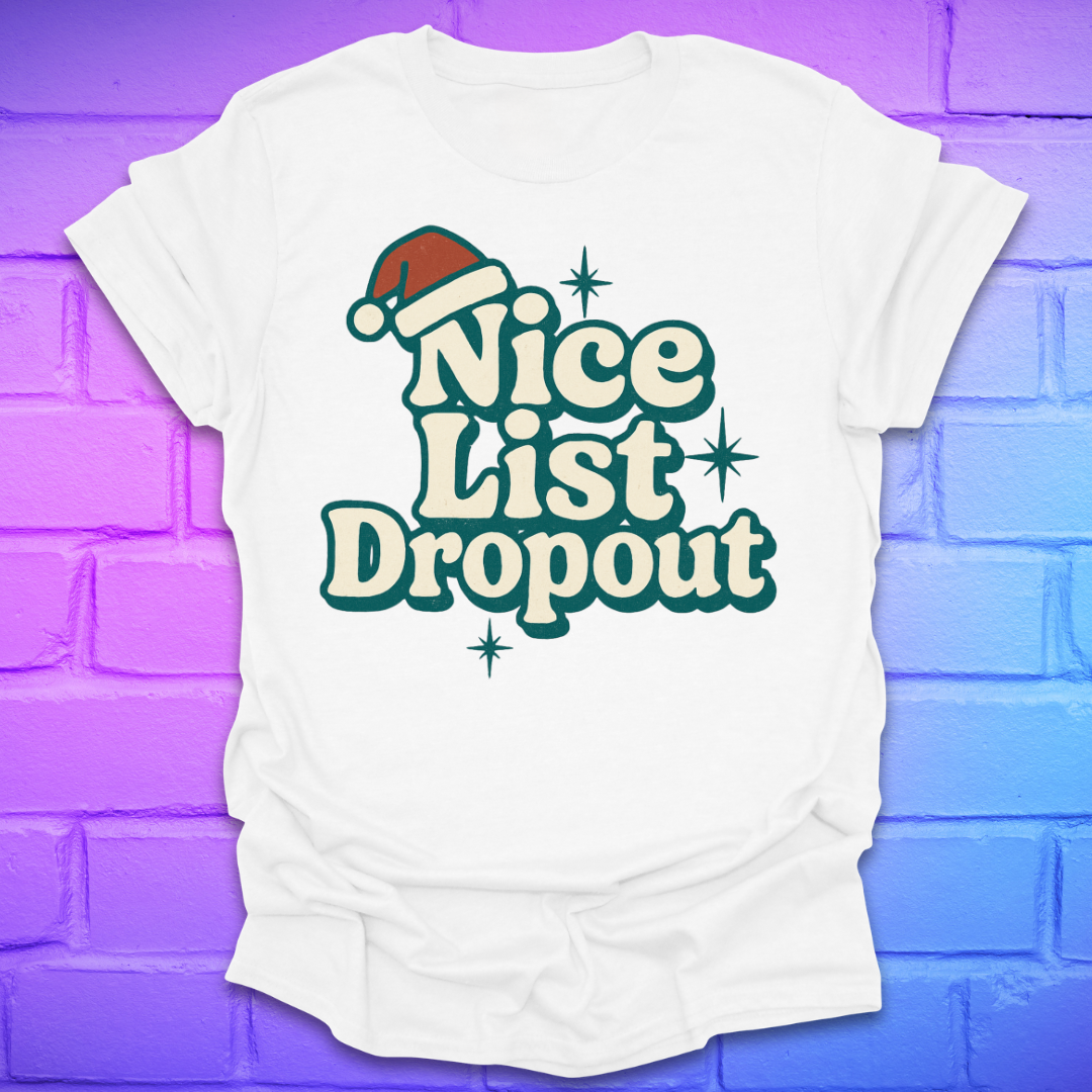 White t-shirt with 'Nice List Dropout' text and Santa hat graphic on a purple brick wall background