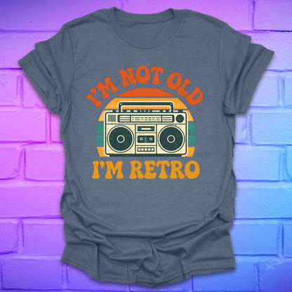Gray t-shirt with 'I'm Not Old, I'm Retro' graphic design on a brick wall background