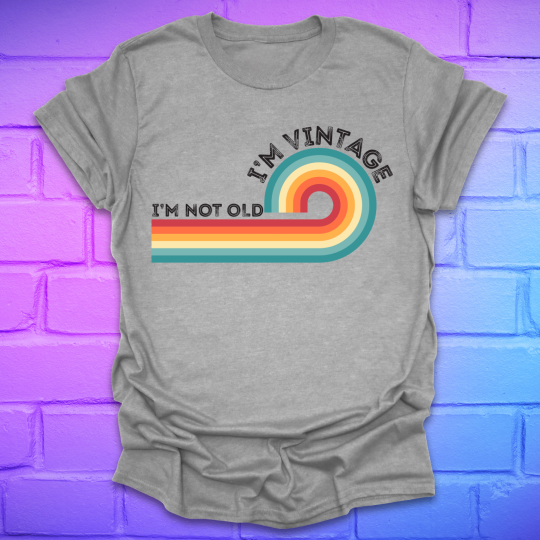 Gray t-shirt with colorful design and text on a blue and purple brick wall background