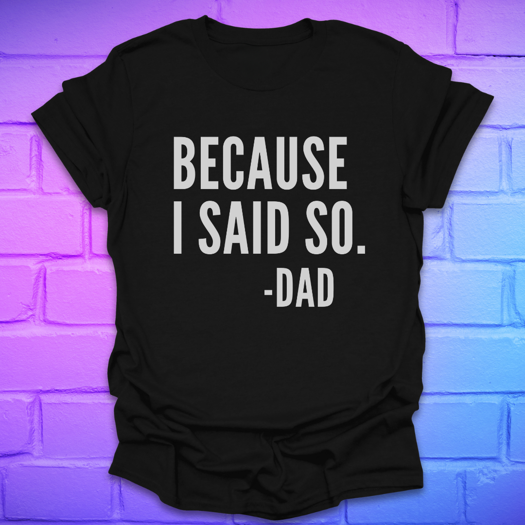Black t-shirt with 'BECAUSE I SAID SO. -DAD' text on a brick wall background