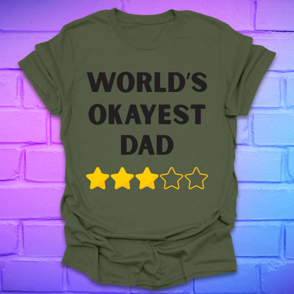 Green t-shirt with 'World's Okayest Dad' text and star ratings on a brick wall background