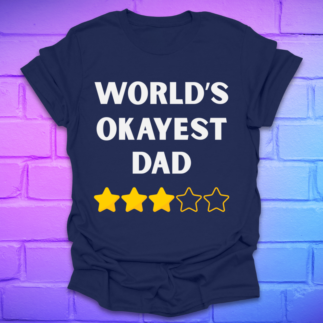 Navy blue t-shirt with 'World's Okayest Dad' text and star ratings on a brick wall background