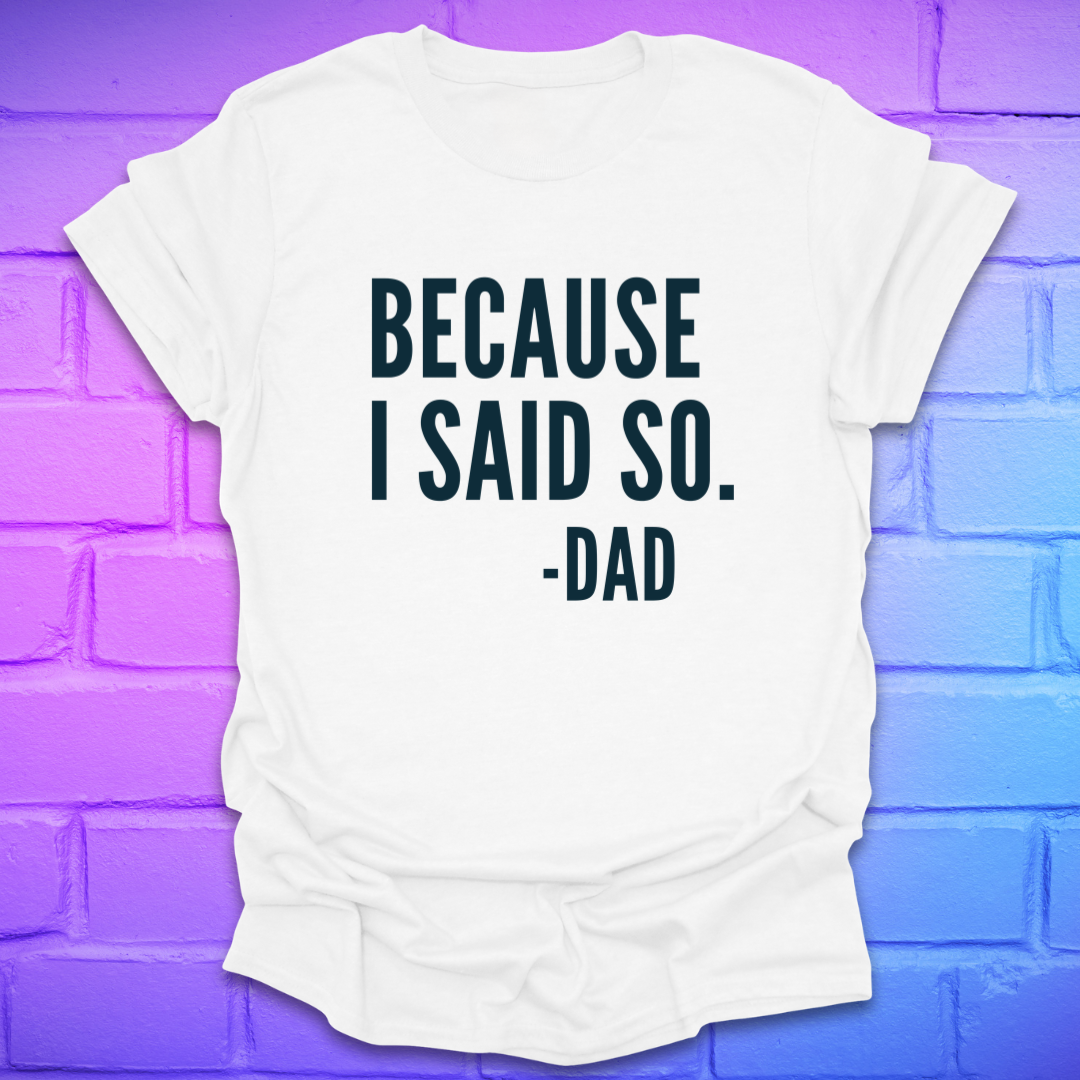 White t-shirt with 'BECAUSE I SAID SO. -DAD' text on a purple brick wall background