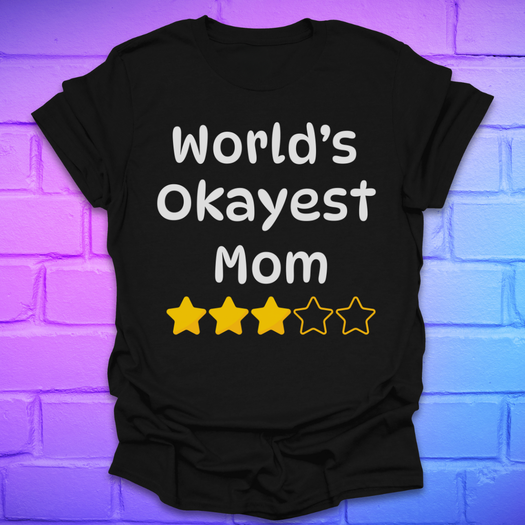 Black t-shirt with 'World's Okayest Mom' text and star ratings on a brick wall background