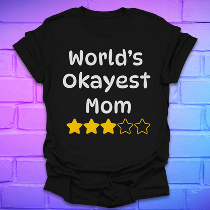 Black t-shirt with 'World's Okayest Mom' text and star ratings on a brick wall background