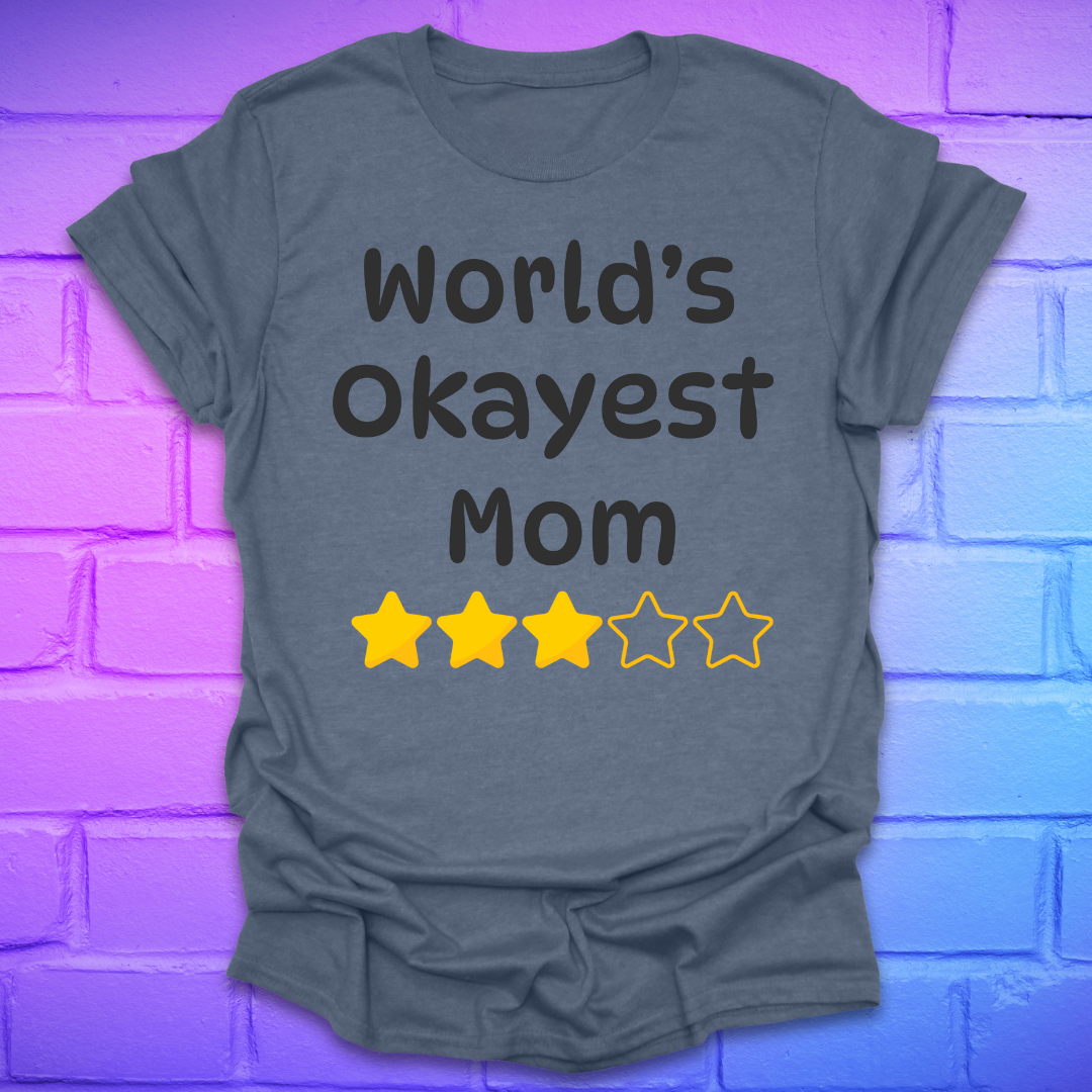 Heather indigo colored t-shirt with 'World's Okayest Mom' text and star ratings on a brick wall background