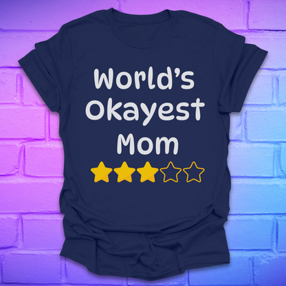 Navy blue t-shirt with 'World's Okayest Mom' text and star ratings on a brick wall background