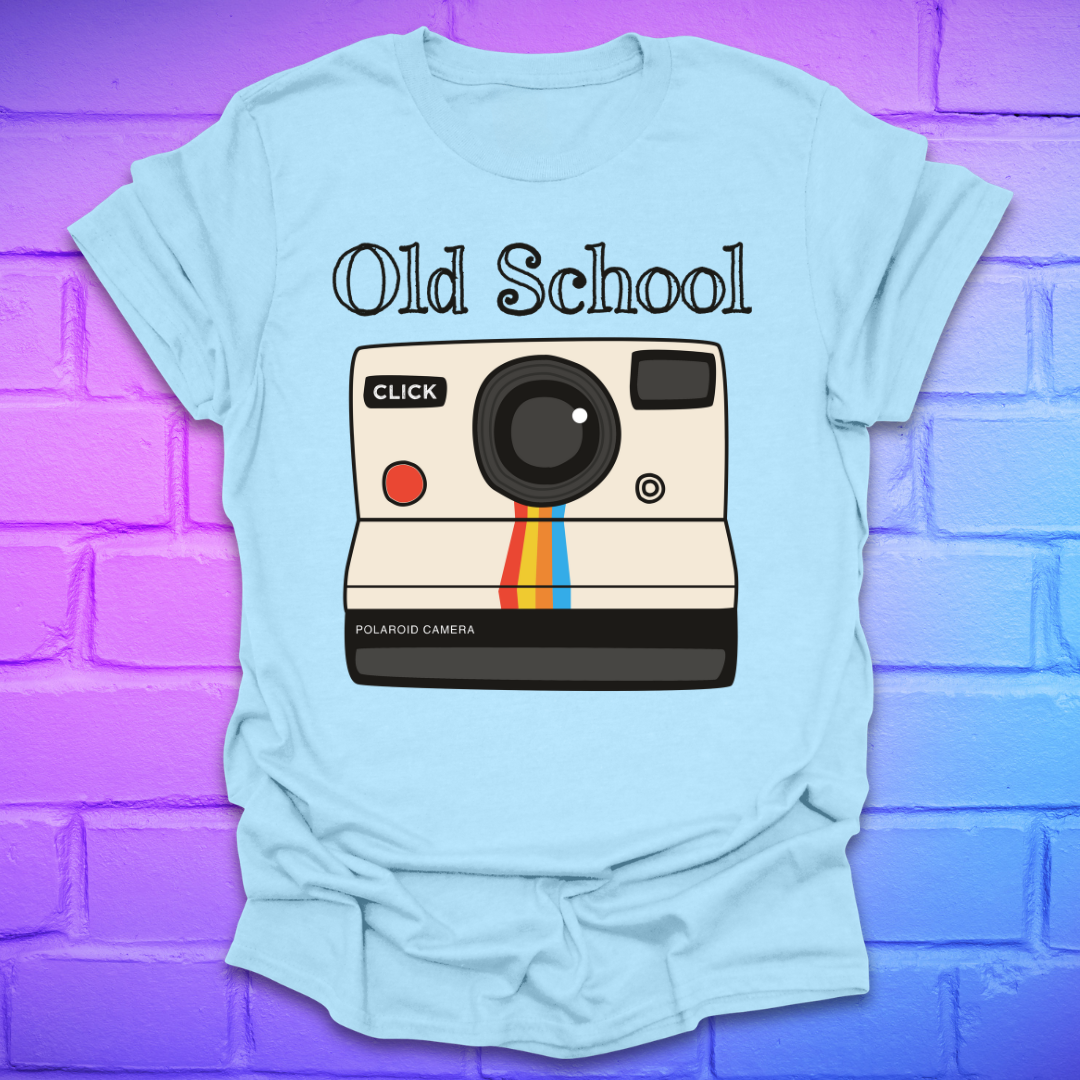 Light blue t-shirt with a graphic of an polaroid camera and 'Old School' text on a brick wall background.