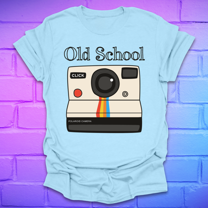 Light blue t-shirt with a graphic of an polaroid camera and 'Old School' text on a brick wall background.