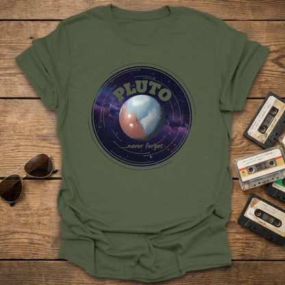 Green t-shirt with Pluto graphic design on a wooden surface with vintage items.