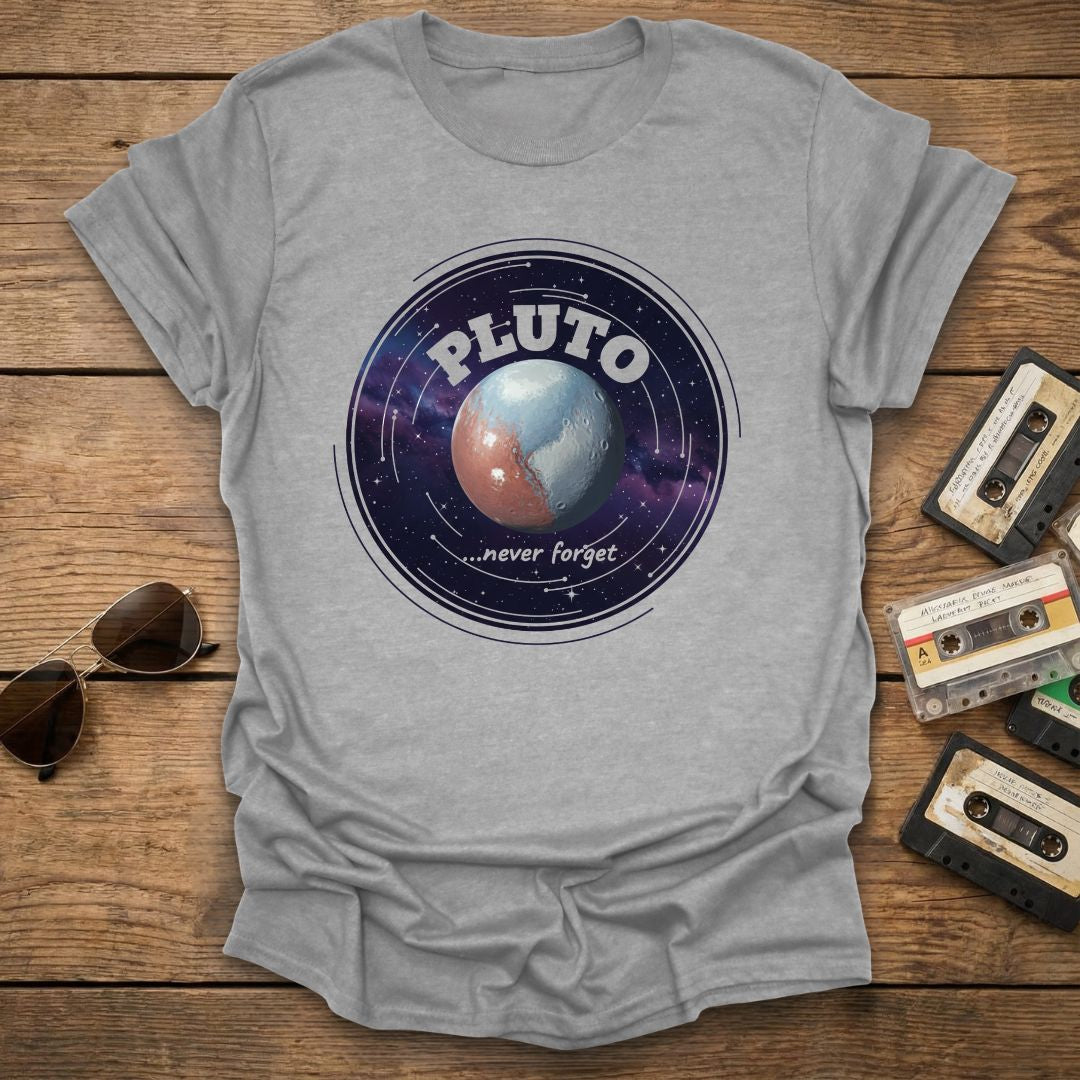 Gray t-shirt with Pluto graphic design on a wooden surface with vintage tapes and sunglasses.