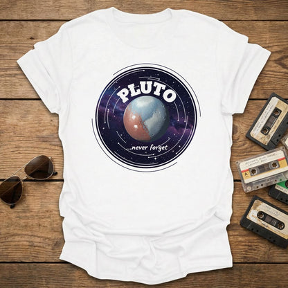 White t-shirt with Pluto graphic design on a wooden surface with vintage tapes and sunglasses.