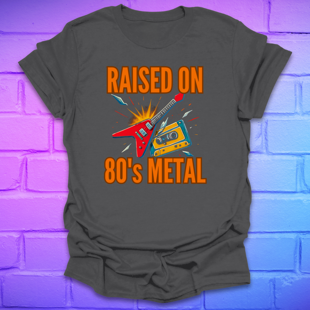 Gray t-shirt with 'Raised on 80's Metal' design featuring a guitar and cassette tape on a purple brick wall background.