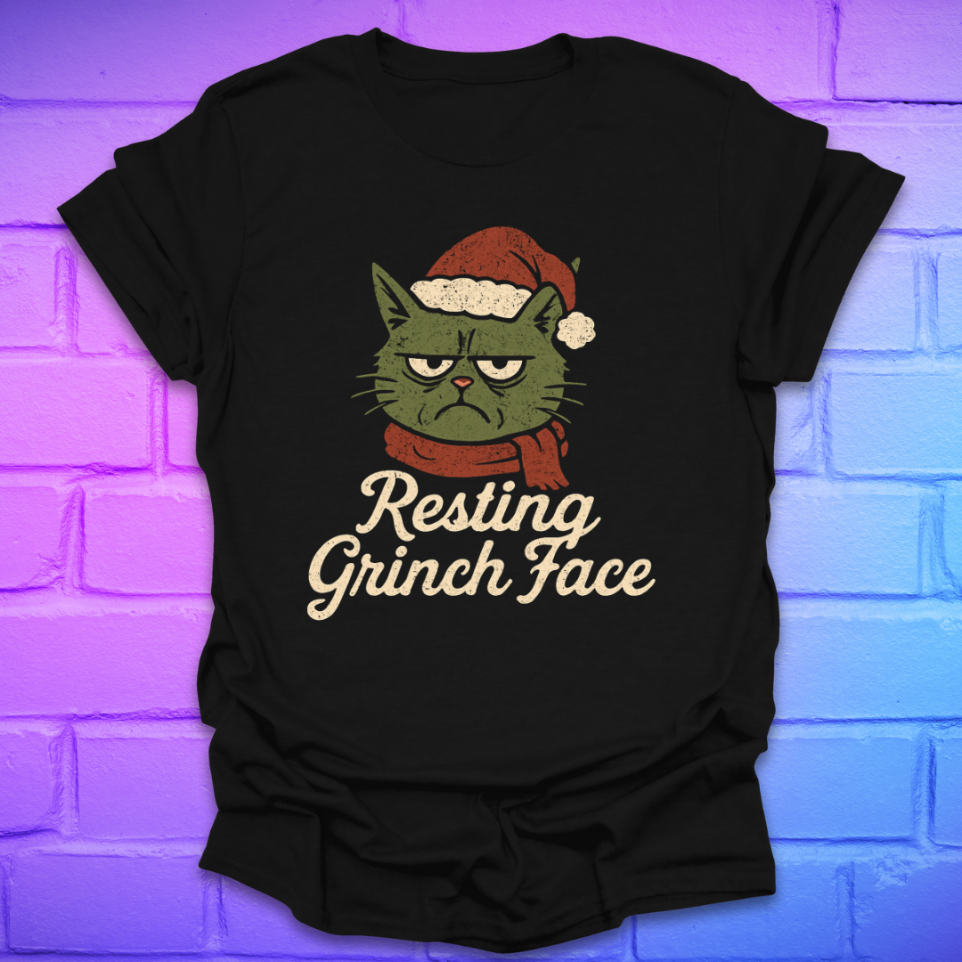 Black t-shirt with a grinch face cat graphic and 'Resting Grinch Face' text on a brick wall background.