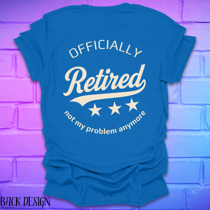Royal blue t-shirt with 'Officially Retired, not my problem anymore' text on a brick wall background