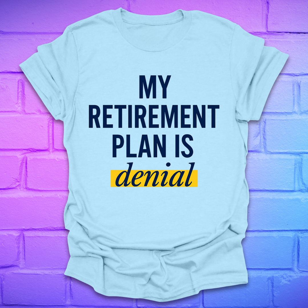 Light blue t-shirt with 'My Retirement Plan is Denial' text on a purple brick wall background