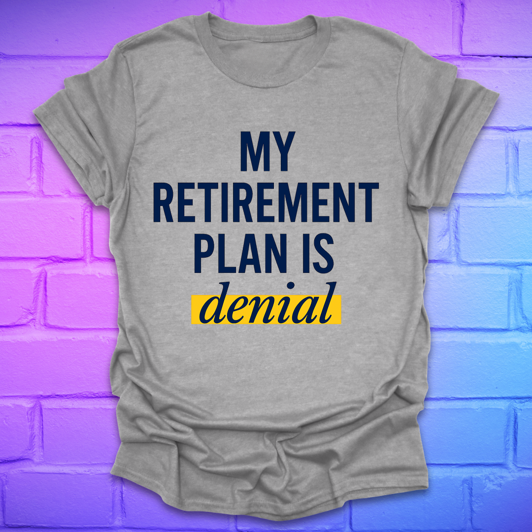 Gray t-shirt with 'My Retirement Plan is Denial' text on a brick wall background