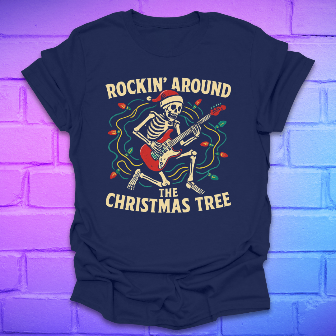 Navy blue t-shirt with skeleton playing guitar graphic and text 'Rockin' Around the Christmas Tree' on a brick wall background.