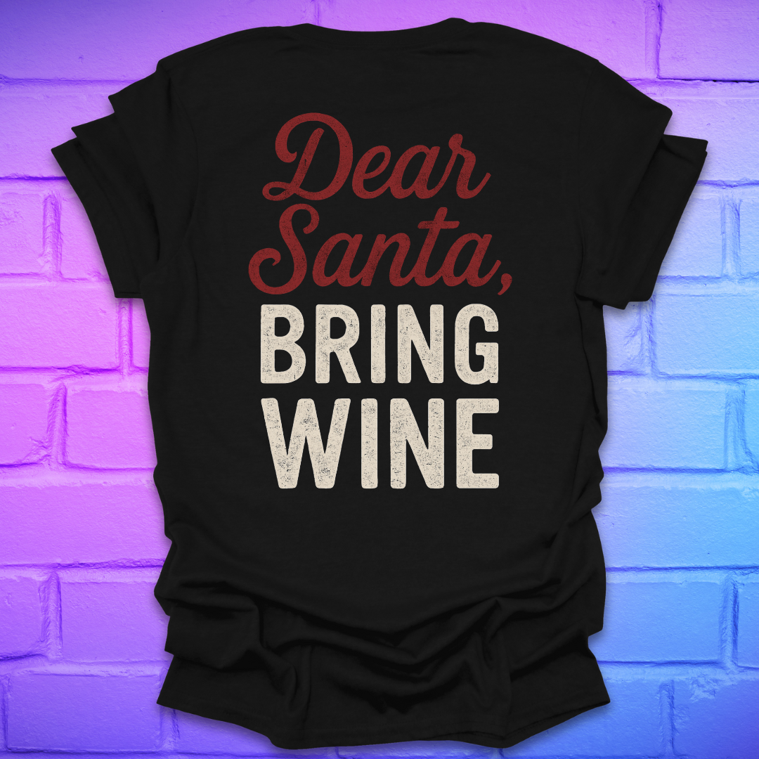 Black t-shirt with 'Dear Santa, Bring Wine' text on the back, on a brick wall background