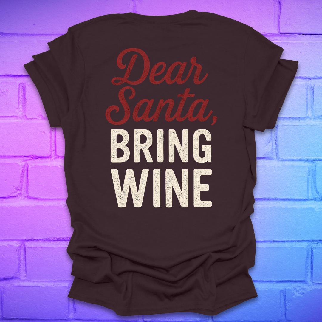 Brown t-shirt with 'Dear Santa, Bring Wine' text on the back, on a brick wall background