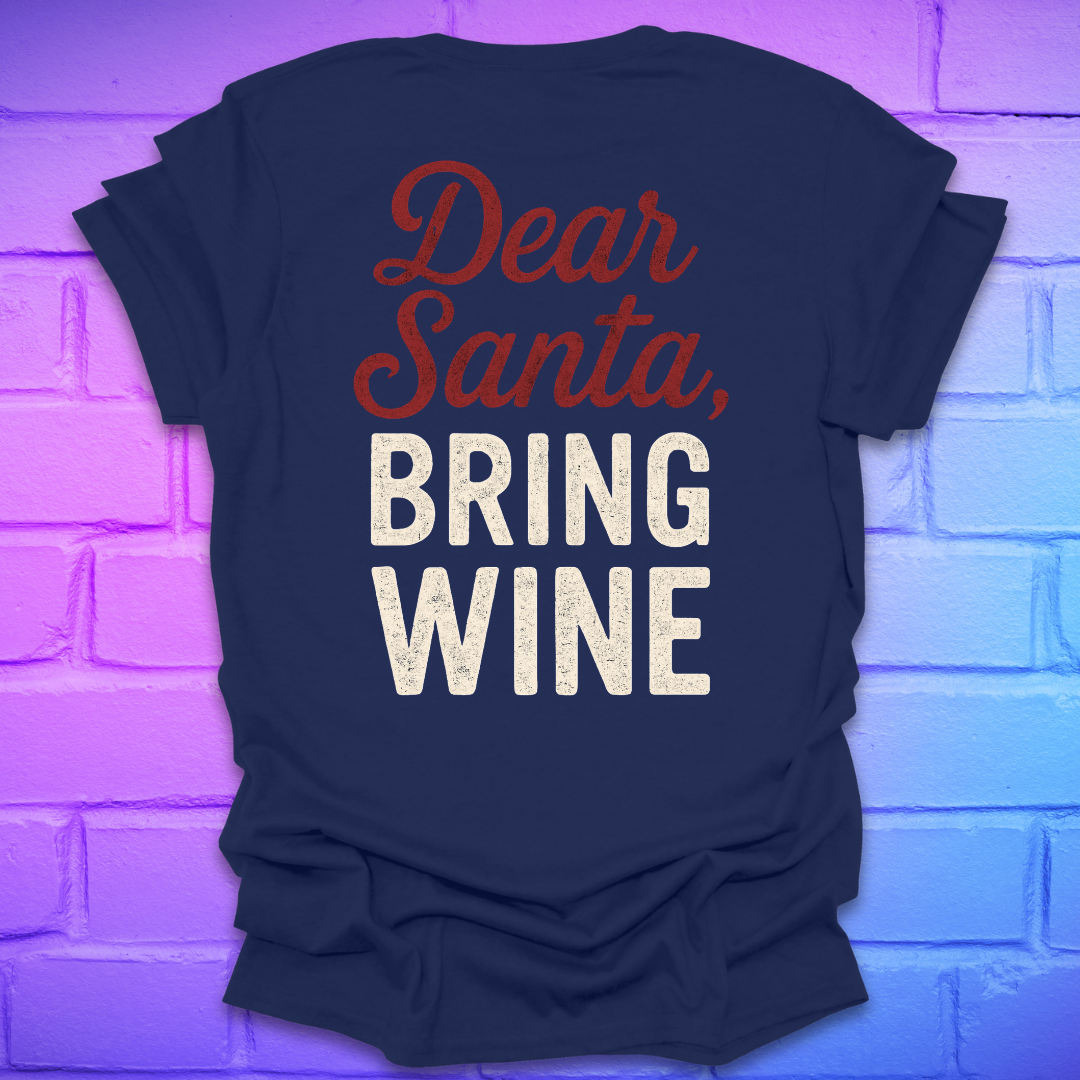 Navy t-shirt with 'Dear Santa, Bring Wine' text on the back, on a brick wall background