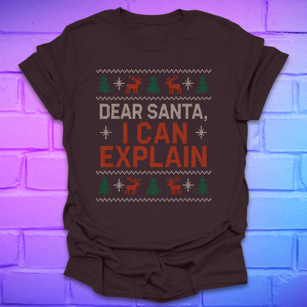 Brown tshirt with text 'dear santa i can explain' with trees and reindeer on a brick background