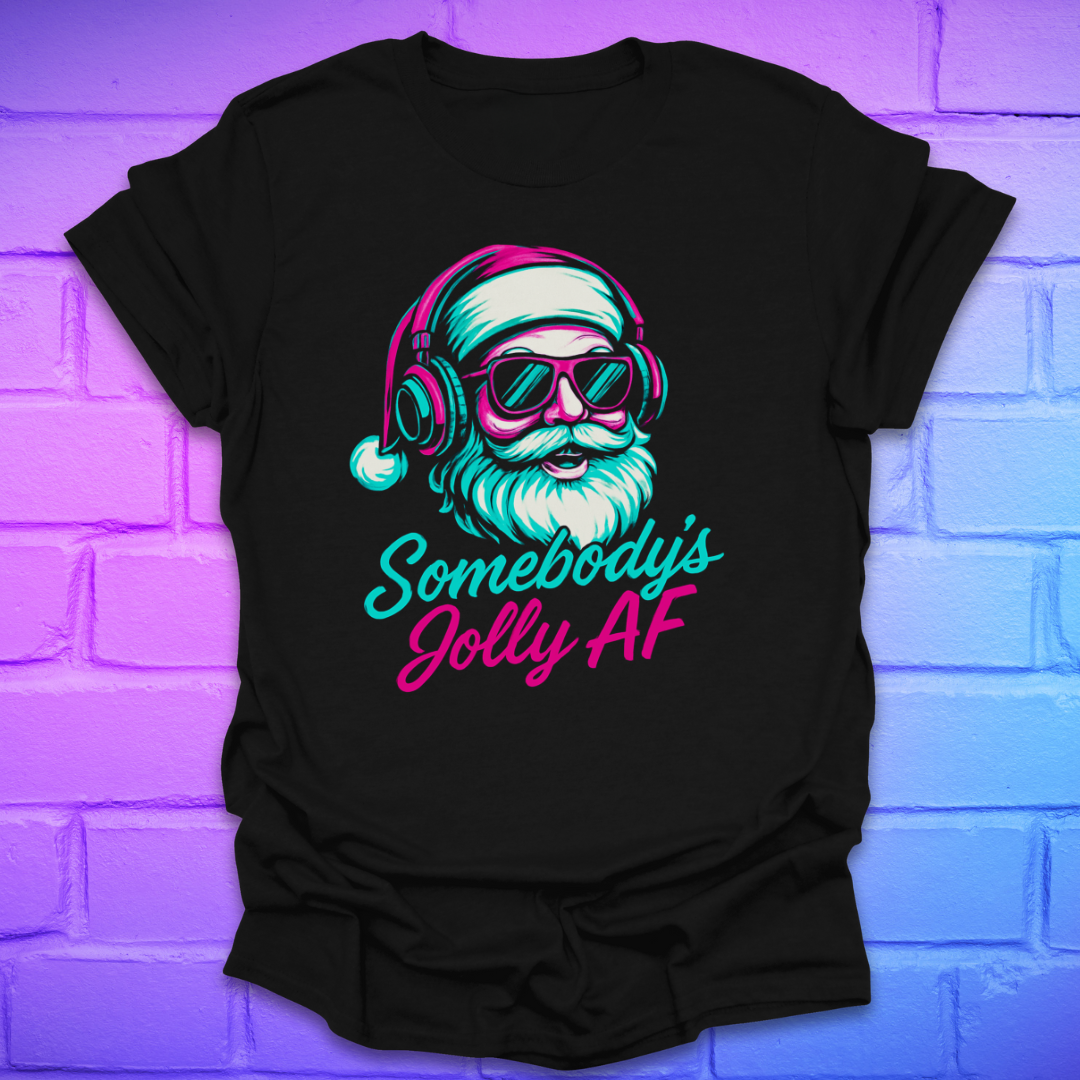 Black t-shirt with a colorful graphic of Santa Claus wearing headphones and sunglasses, text 'Somebody's Jolly AF' on a brick wall background.