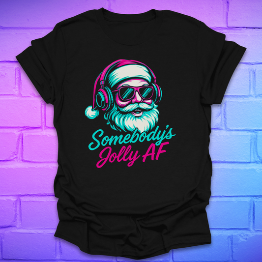 Black t-shirt with a colorful graphic of Santa Claus wearing headphones and sunglasses, text 'Somebody's Jolly AF' on a brick wall background.