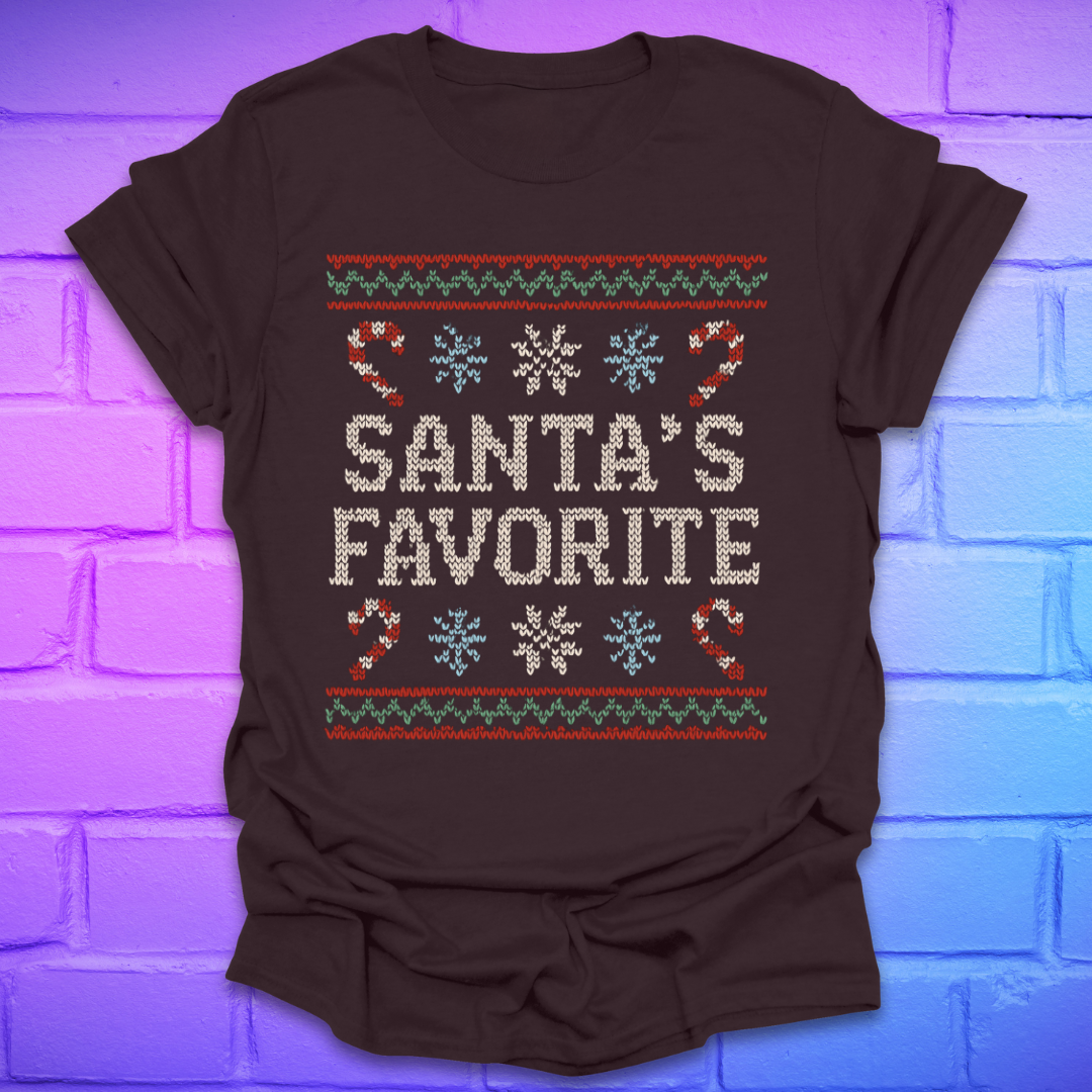 Brown t-shirt with Christmas-themed design, and text, 'Santa's Favorite' on a brick wall background