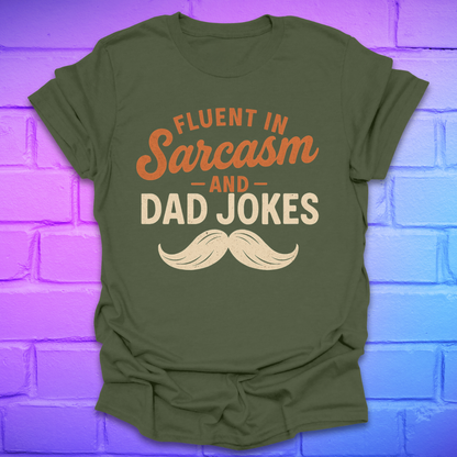 Green t-shirt with 'Fluent in Sarcasm and Dad Jokes' text on a brick wall background