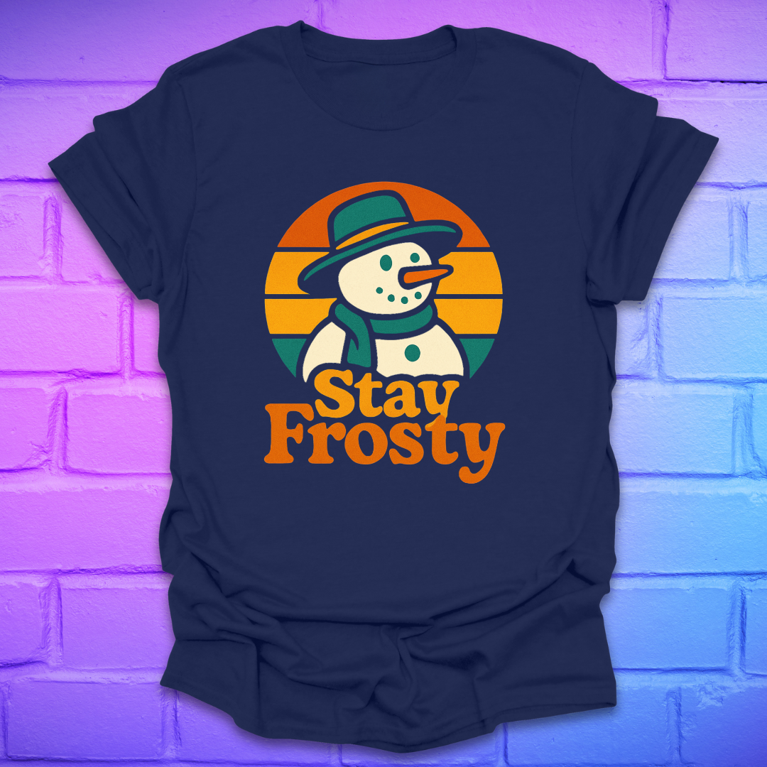 Navy blue t-shirt with a snowman graphic and 'Stay Frosty' text on a brick wall background