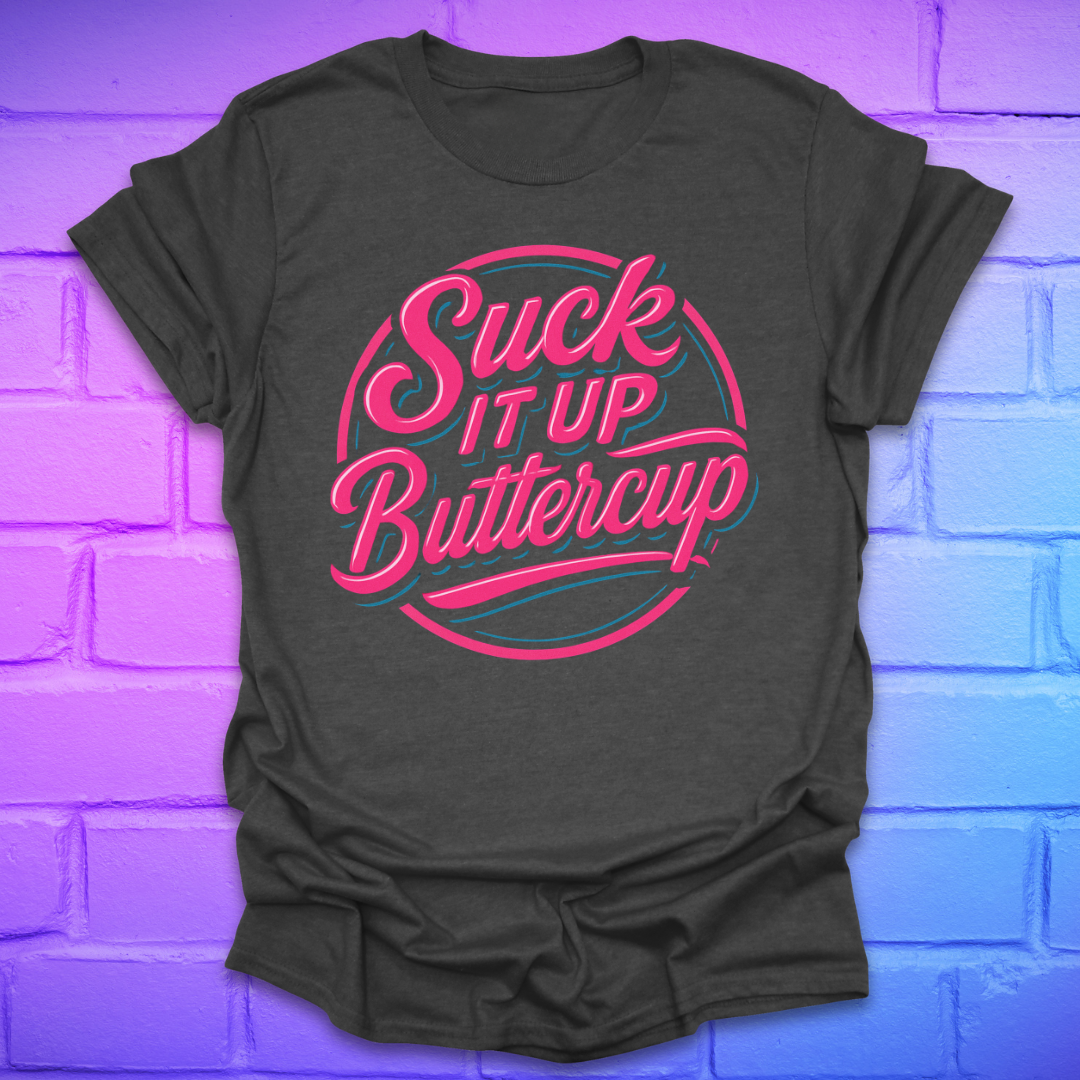 Dark grey t-shirt with 'Suck It Up Buttercup' text in pink and blue on a brick wall background