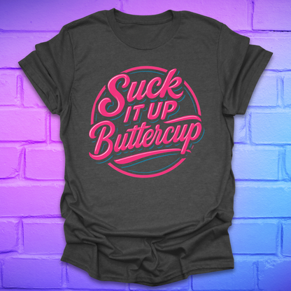 Dark grey t-shirt with 'Suck It Up Buttercup' text in pink and blue on a brick wall background