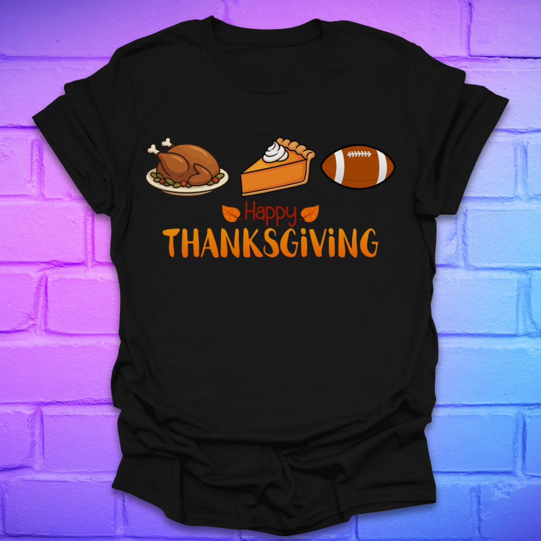Black t-shirt with thanksgiving theme and text, 'happy thanksgiving' with turkey, pie and football, on a brick background.
