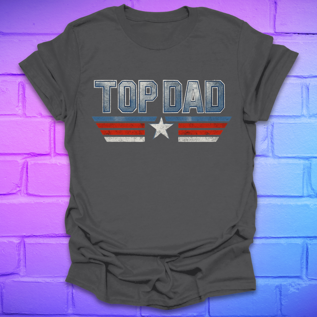 Grey t-shirt with text 'Top Dad' with red, white and blue stripes and a star on a brick background.