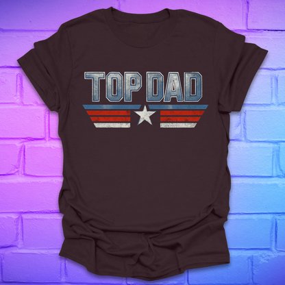 Brown t-shirt with text 'Top Dad' with red, white and blue stripes and a star on a brick background.