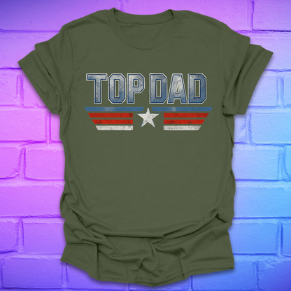 Green t-shirt with text 'Top Dad' with red, white and blue stripes and a star on a brick background.