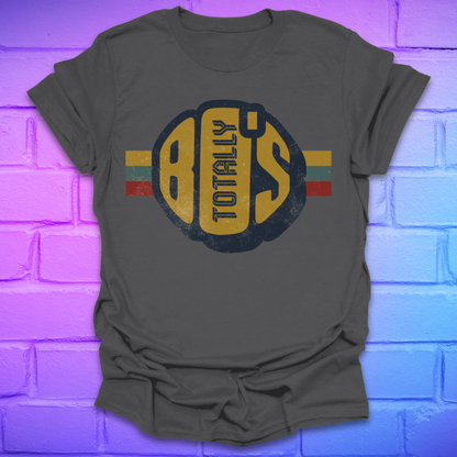 Charcoal colored t-shirt with a large retro graphic reading 'Totally 80's' with a colorful stripe on a brick background.