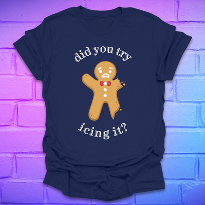 Navy blue t-shirt with a gingerbread man graphic and text, 'did you try icing it?' on a purple brick wall background