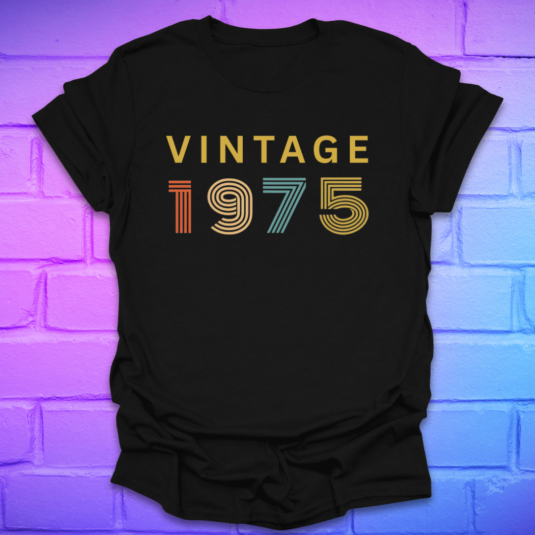 Black tshirt with text 'Vintage 1975' in a retro font, on a brick background.